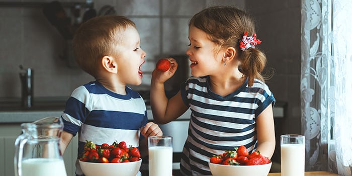 children eating healthy strawberries