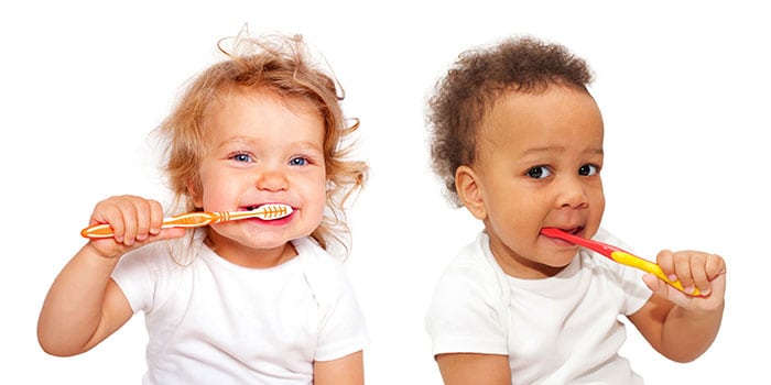 young children brushing their teeth