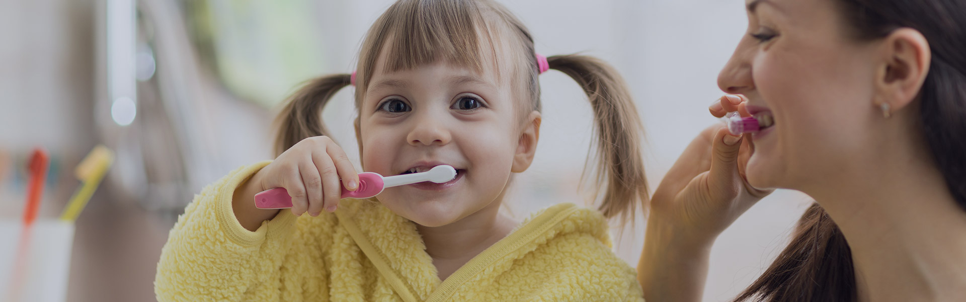Child and Mother Brush Teeth
