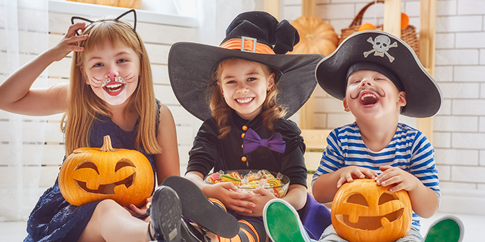 happy healthy halloween children laughing with treats