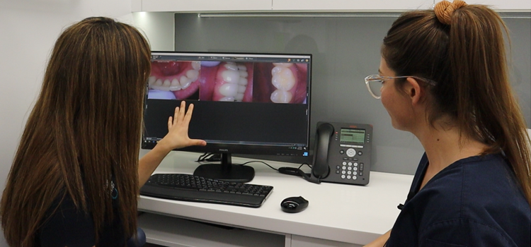 Dr Norah and Samantha Nowlan assessing a patients oral scan images