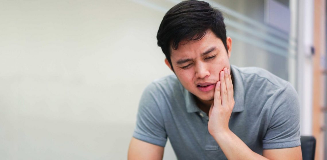 close up asian middle aged man feeling hurt from toothache symptom , unhealthy life concept